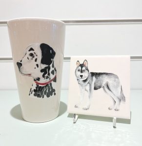 Dog portraits on a cup and a tile